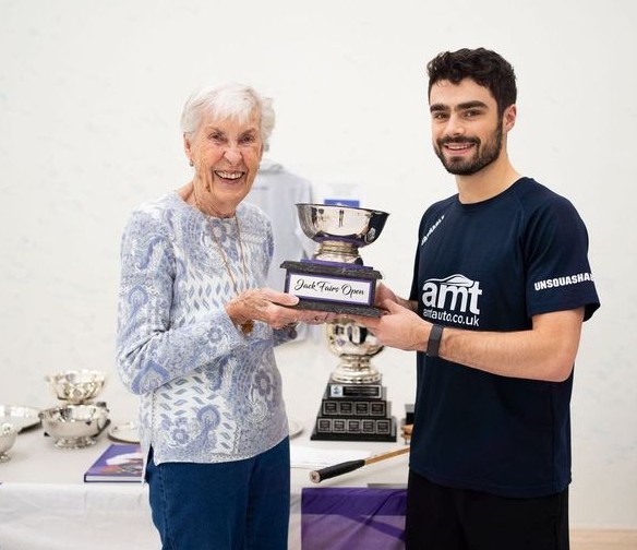 Brett Schille, Jack Fairs Open 2024 Champion, holding trophy with Peg Fairs